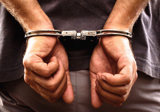 Arrested man handcuffed hands at the back