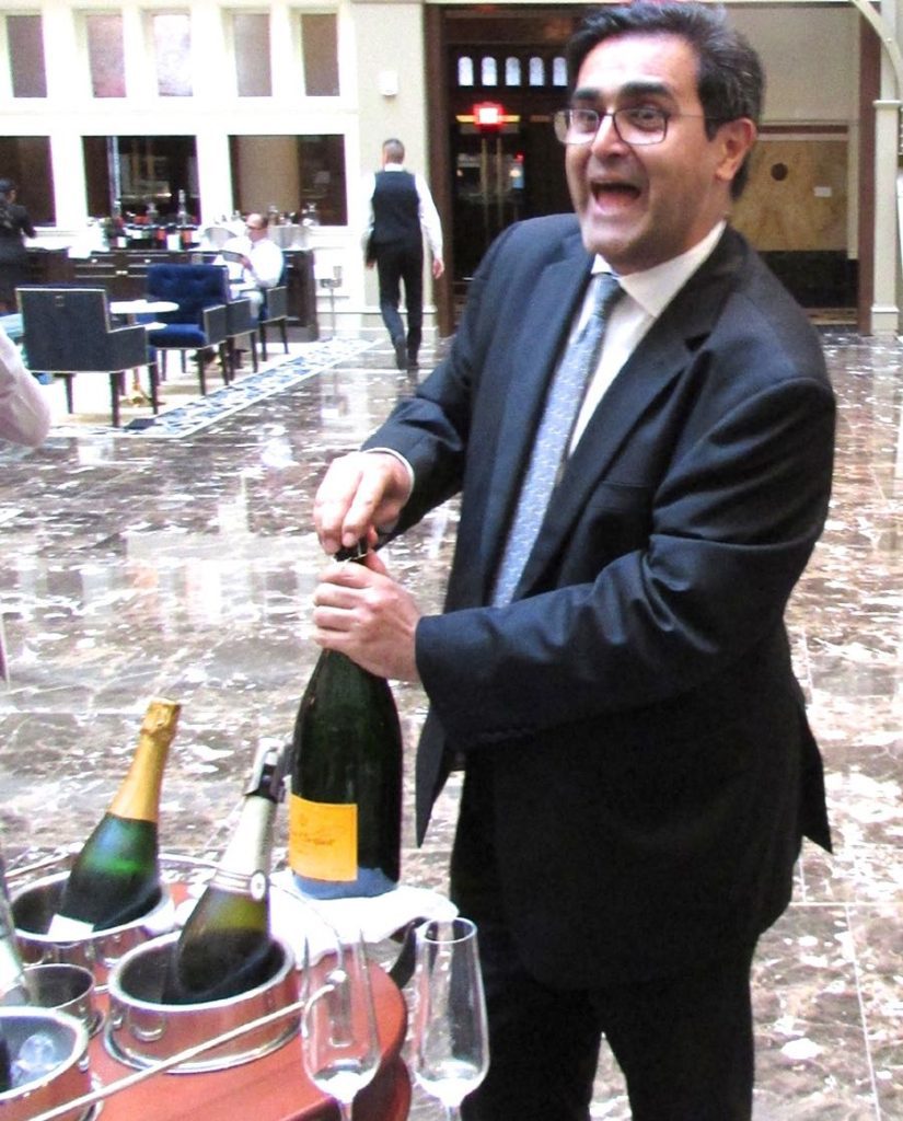 daniel-mahdavian-director-of-food-and-beverages-amazingly-de-cork-a-magnum-of-veuve-clicquot-champage-with-a-saber